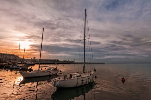 Pleasure boats moored in harbor at sunset. Trieste Italy