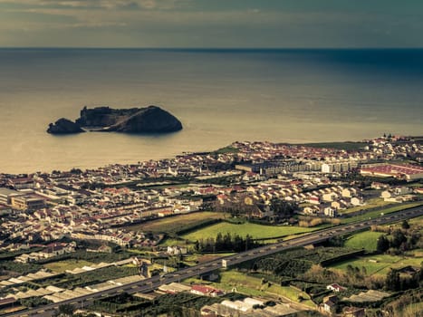 View of the small Ilheu da vila island which a popular summer retreat for people in Vila Franca do Campo in Sao Miguel Island in the Azores.