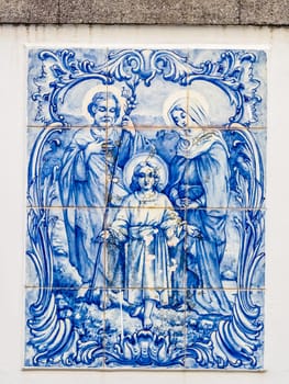 Porcelain plaque depicting the Holy Family on the wall above door in the Ponta Delgada town in Sao Miguel, Azores Island, Portugal