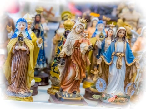 Small statuettes of saints on sale in a shop in Ponta Delgada, Sao Miguel Island, Azores, Portugal