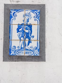 Porcelain plaque on the wall above door in the Ponta Delgada town in Sao Miguel, Azores Island, Portugal