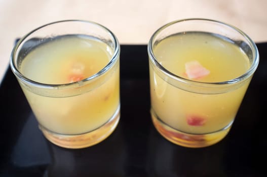 Two melon cocktails with ham over black clay tray. Selective focus