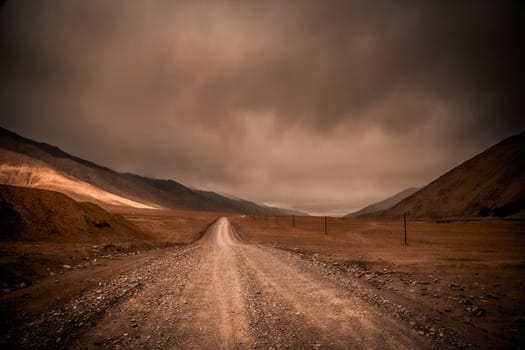 Endless mountain road through the high central Tibetan plateau, Tibet, China