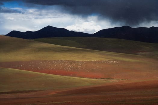 Snow falling on the mountain slopes in the landscape of the remote area of Western Tibet