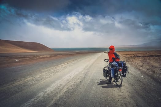 Solo female cyclist on the bicycle in the stunning remote part of Western Tibet