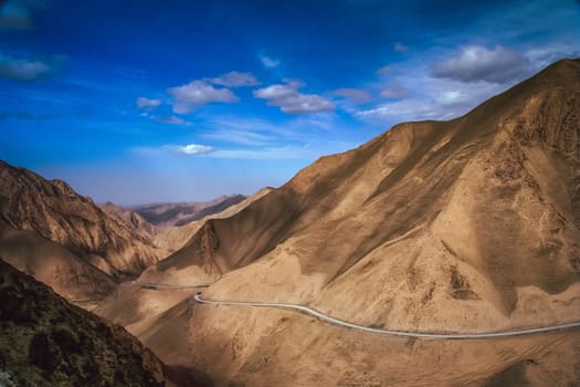 Twisting mountain road in Xinjang province in China leading to Western Tibet