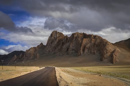 Paved mountain road through the high central Tibetan plateau, Tibet, China