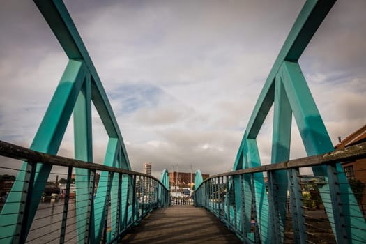 Green steel bridge in Bristol harbour, England, UK