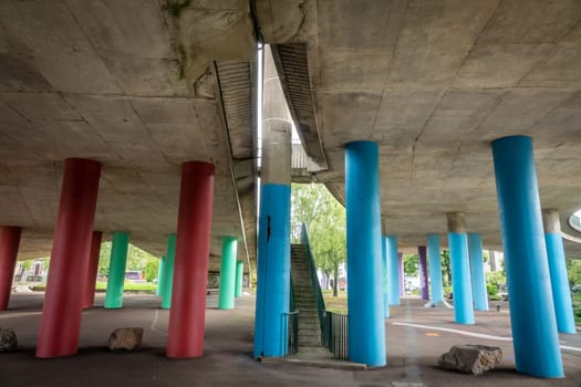 Concrete red and green girder piers of a highway on the outskirts of Bristol, England, UK
