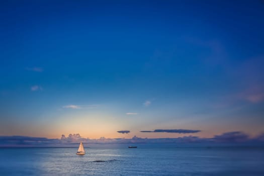 Small sailboat on a calm sea in Penzance, Cornwall, England, UK