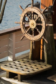Wooden steering wheel on an old ship