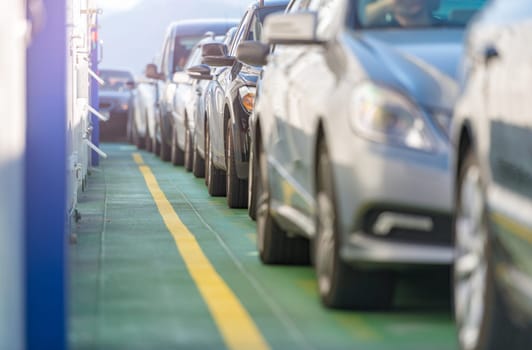 Cars waiting in line on deck of ferry in Norway, Scandinavia, Europe. Water transportation.