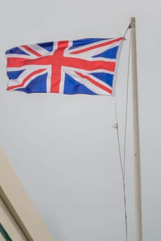 British flat on a mast fluttering in a strong wind