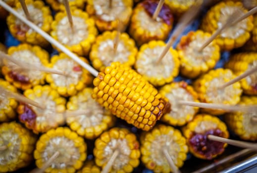 Fresh corn grilled during an outdoors barbecue