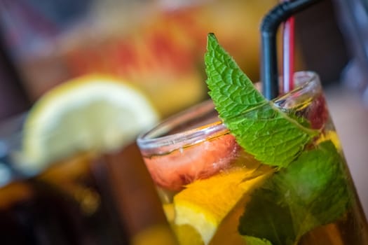 Glasses containing pimms drink and cola on a table in a pub