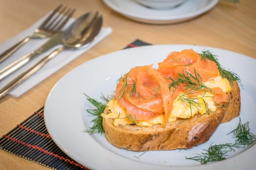 Smoked salmon with scrambled eggs on toast