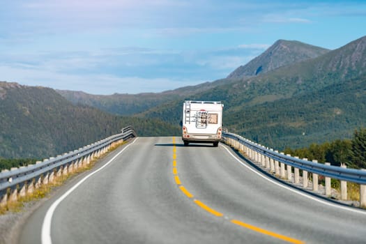 Recreational vehicle on mountain road in Norway, Europe. Car travel through scandinavia. Blue sky and mountains in background.