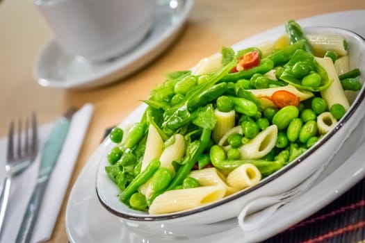 Close-up of freshly made green vegetables penne pasta