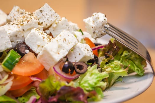 Summer Greek salad with olives, tomatoes, cucumber and feta cheese