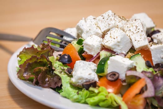 Summer Greek salad with olives, tomatoes, cucumber and feta cheese