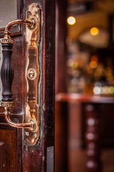 Door handle at the entrance to the traditional English pub in London, UK