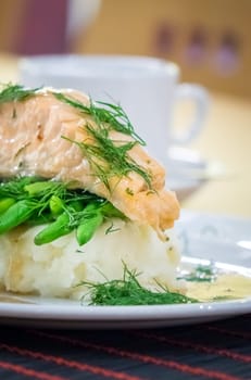 Roast salmon main course served with mashed potatoes and green beans