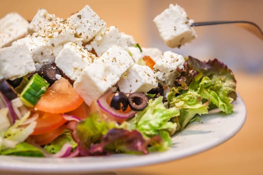 Summer Greek salad with olives, tomatoes, cucumber and feta cheese
