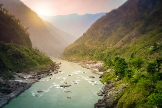 Torquoise river, flowing through the beautiful mountain valley in the mountains of Nepal