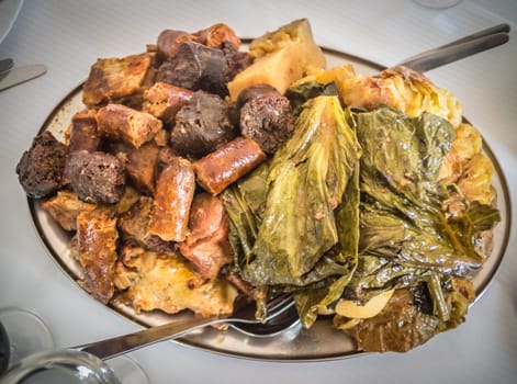 Traditional Furnas stew which is cooked for many hours in the volcanic vents in the ground. It consists of various meats - chicken, beef, pork, chorizo, lamb as well as potatoes and cabbage
