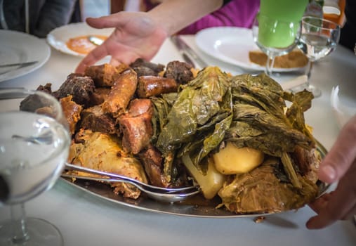 Traditional Furnas stew which is cooked for many hours in the volcanic vents in the ground. It consists of various meats - chicken, beef, pork, chorizo, lamb as well as potatoes and cabbage