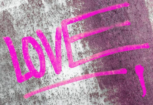 Word LOVE written over the grunge rusty background