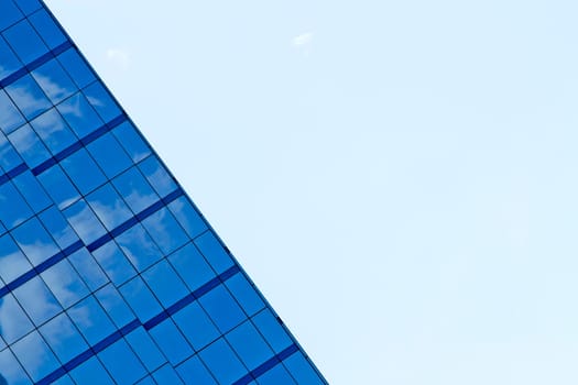 The building reflects with blue sky.