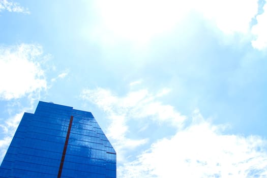 The building reflects with blue sky.