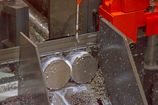 Hacksaw machine on cutting for round steel coolant in motion
