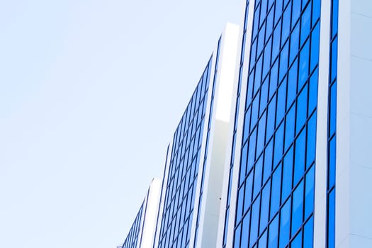 Blue sky reflected on blue building side