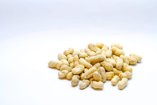 Many peanuts in the shell on a white background