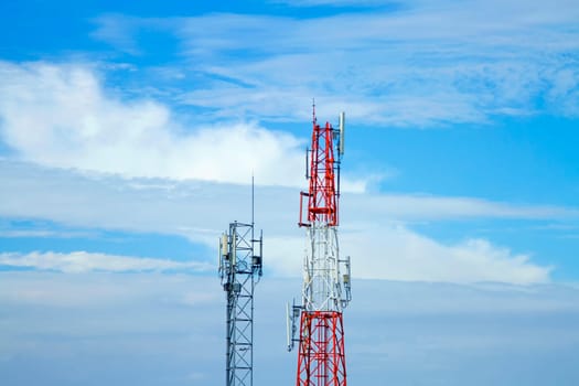 Mobile phone communication tower transmission  signal with blue sky background and antenna and twin