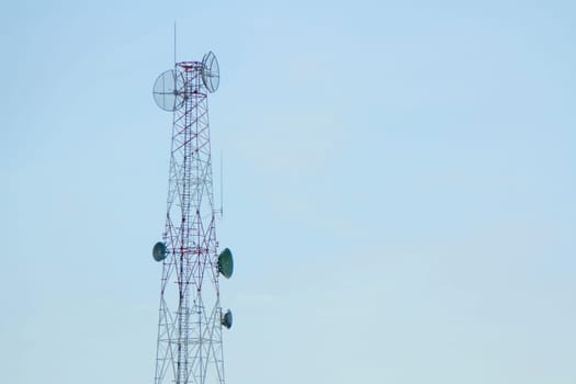Mobile phone communication tower transmission with blue sky background and antenna