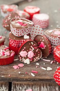 Homemade confectionery with sugar sprinkles in small heart tubes made of aluminium
