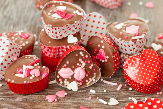 Homemade confectionery with sugar sprinkles in small heart tubes made of aluminium