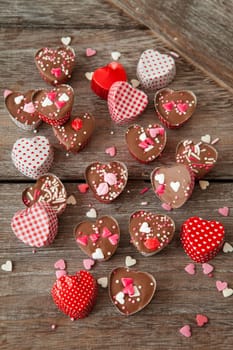 Homemade confectionery with sugar sprinkles in small heart tubes made of aluminium