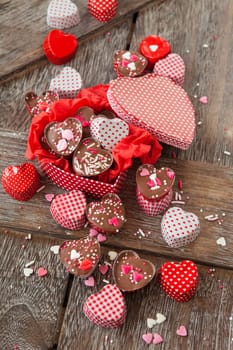 Homemade confectionery with sugar sprinkles in small heart tubes made of aluminium