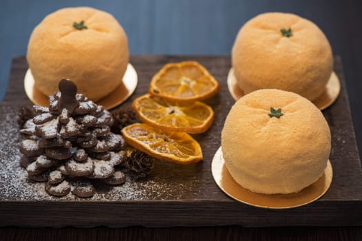Tasty dessert as orange fruit with chocolate fir-tree for new year holiday