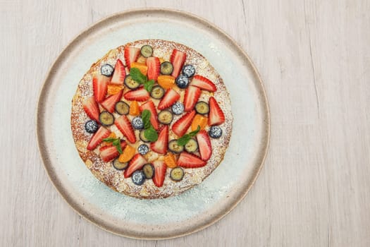 Sweet bright cakes with fruit and berries