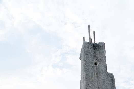 Old cement pillar with white sky background