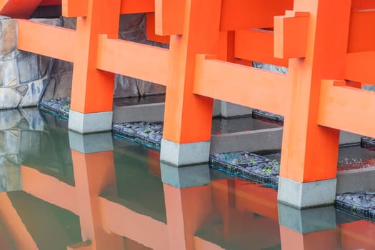Columns of the red bridge with brook