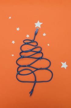 Tech New Year: fir-tree from wires on orange background