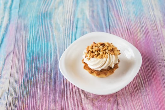 Tasty mini cake with nuts on a color gradient background