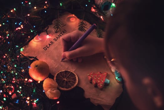 Boy writes a letter to Santa, cristmas background