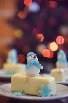Christmas dessert with snowman on lights bokeh background
